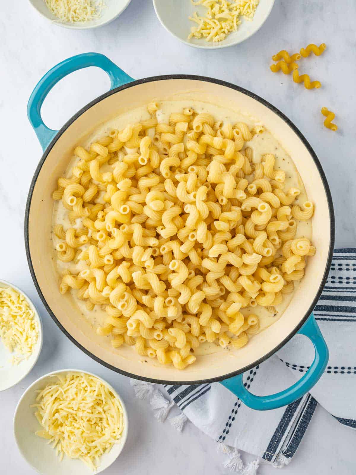 Combine cooked cavatappi pasta with cheese sauce.