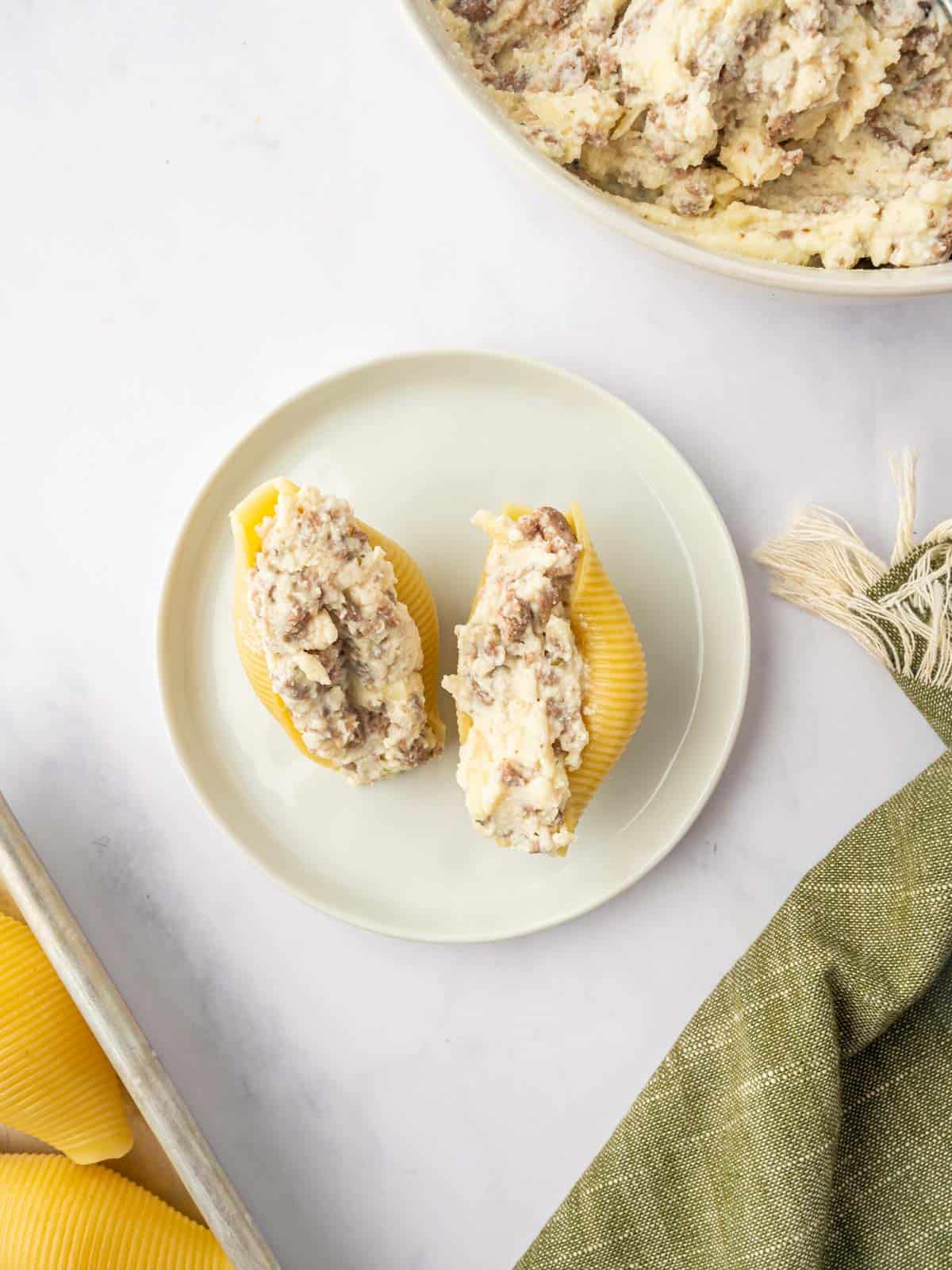 Cooked pasta shells filled with the cheese and beef mixture.