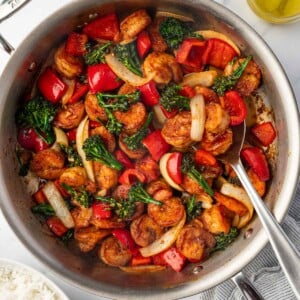 Panda express shrimp in a skillet with a spoon.