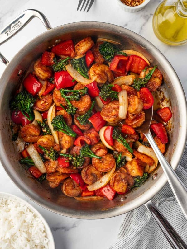 Panda express shrimp in a skillet with a spoon.