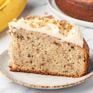 Side view of banana cake with cream cheese frosting.