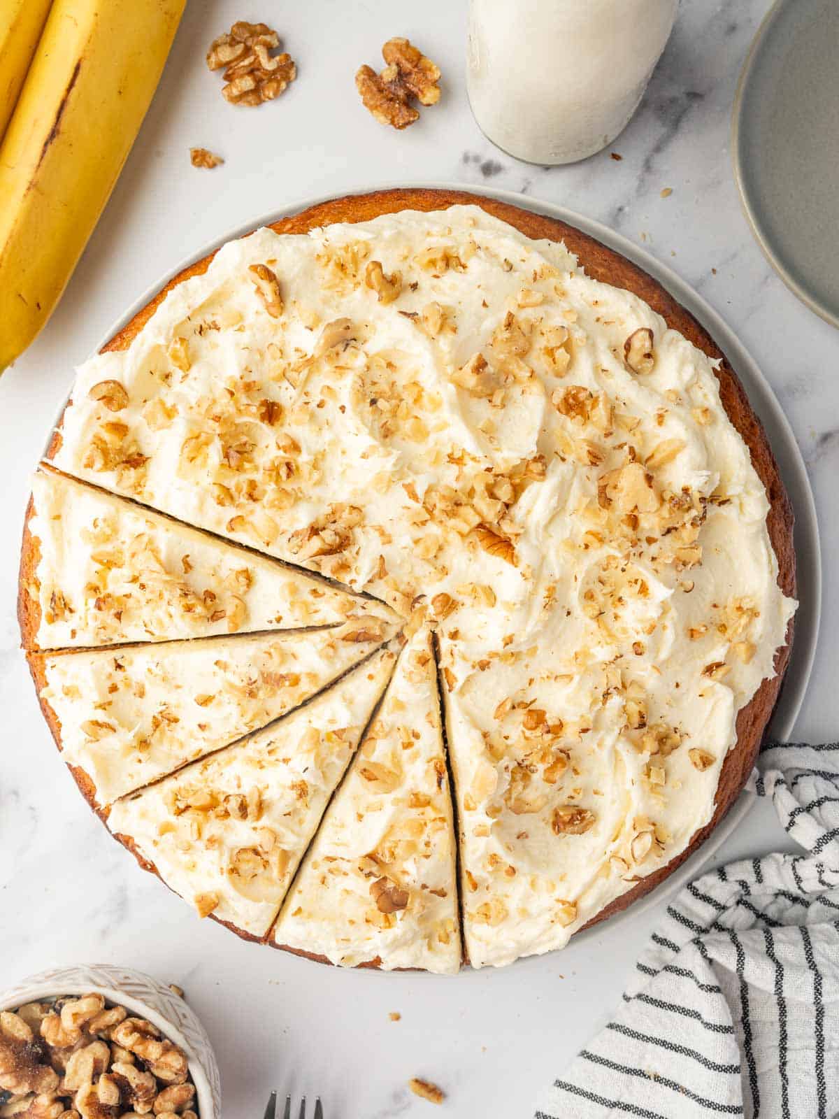 Slices are cut into a banana walnut cake.