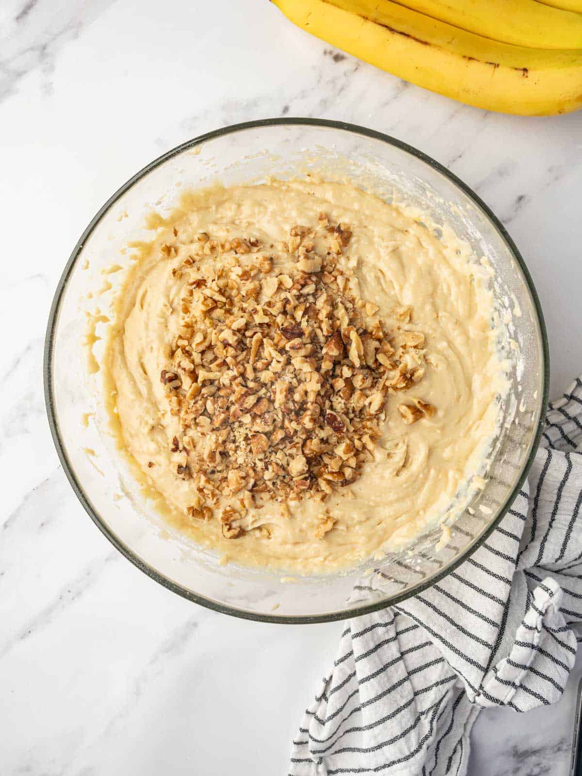 Folding walnuts into the cake batter.