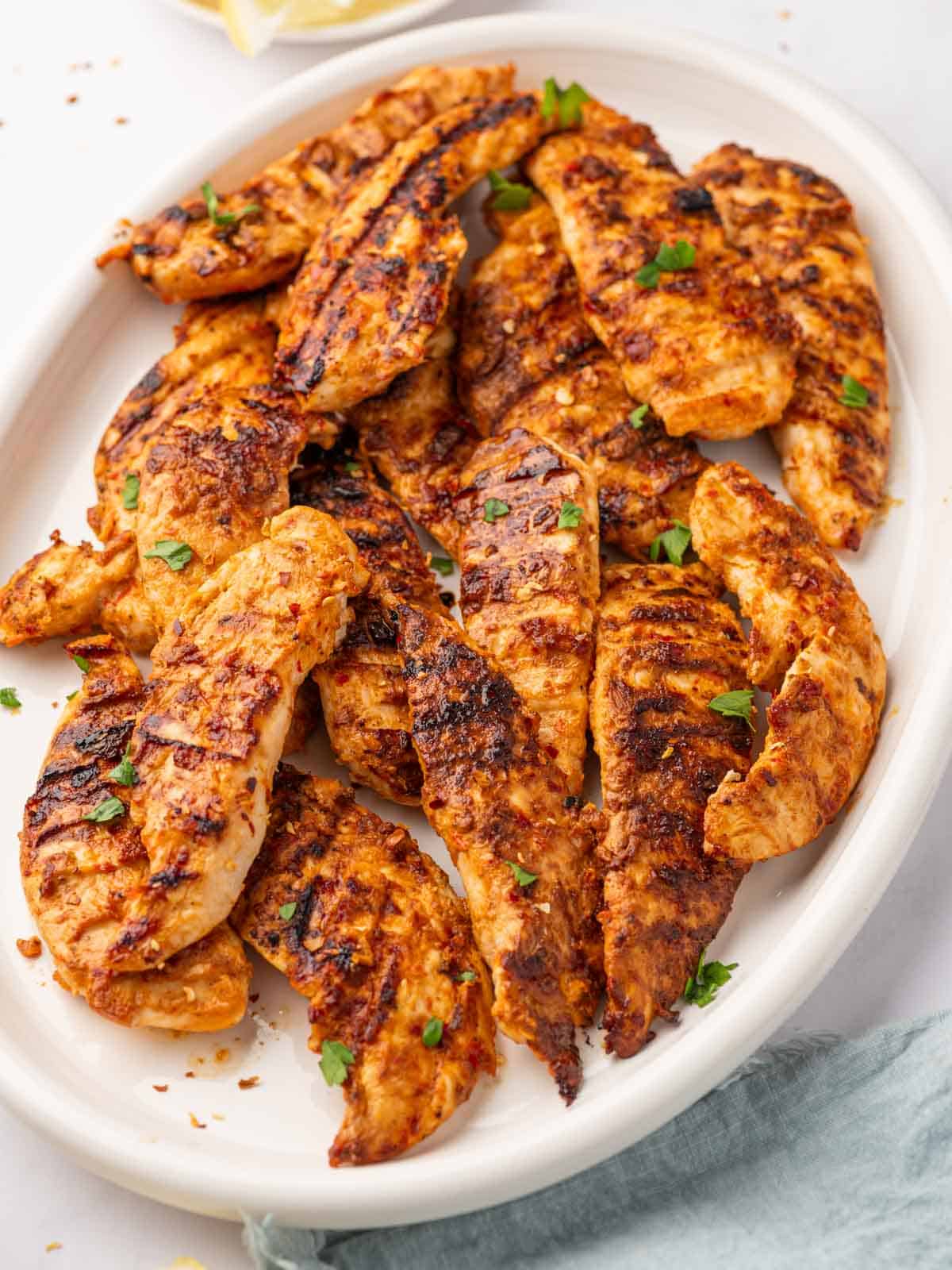 A pile of spicy chicken tenders on a plate.