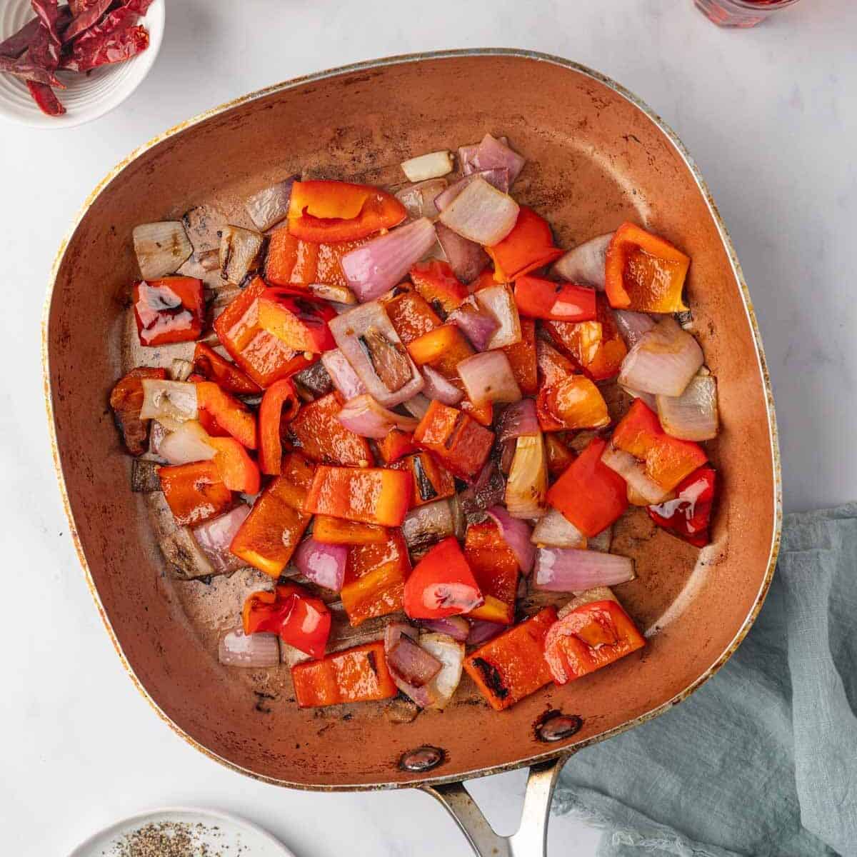 Onions and bell peppers are sauteed until tender.