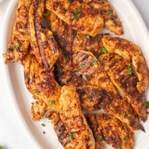 Grilled peri peri chicken on a platter.