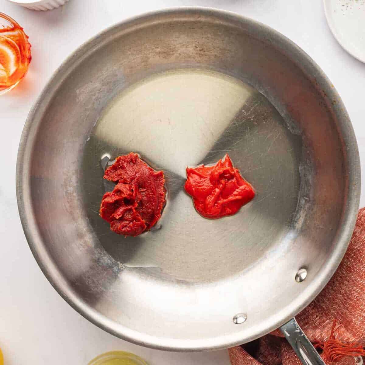 Tomato paste mixture in a pan before cooking.
