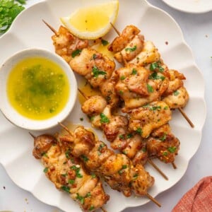 Chicken skewers on a plate.