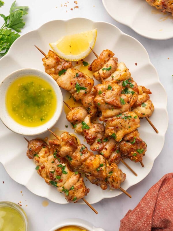 Chicken skewers on a plate.