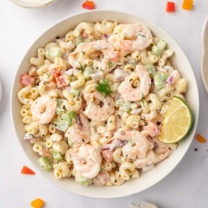 Macaroni salad with shrimp in a bowl.