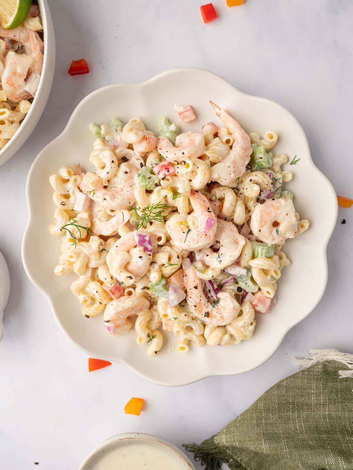 A serving of macaroni salad with shrimp on a plate.