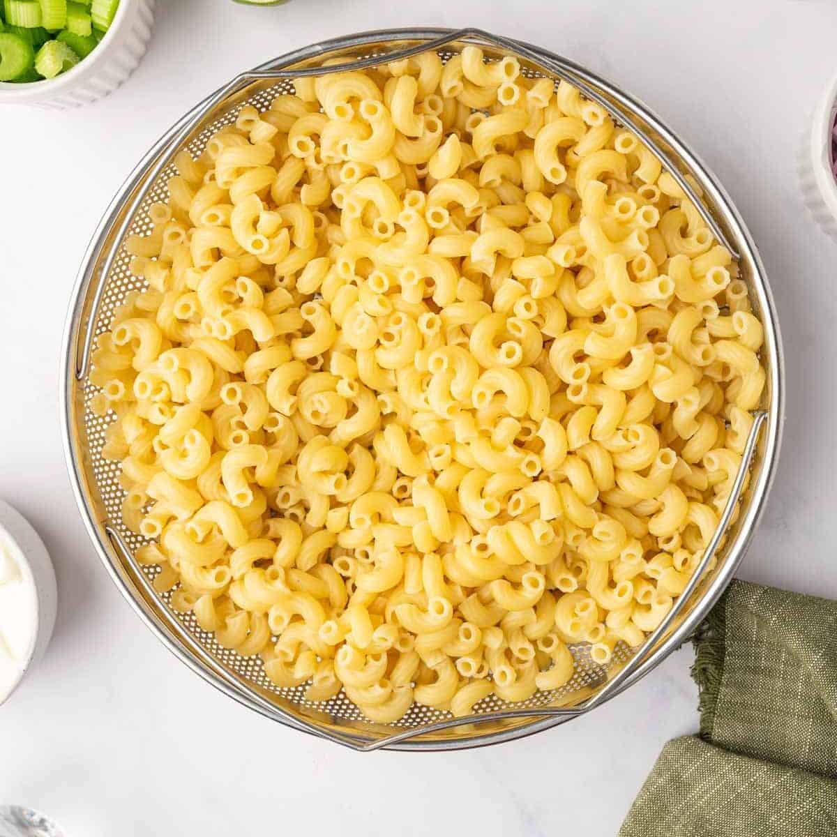 Cooked macaroni in a colander.