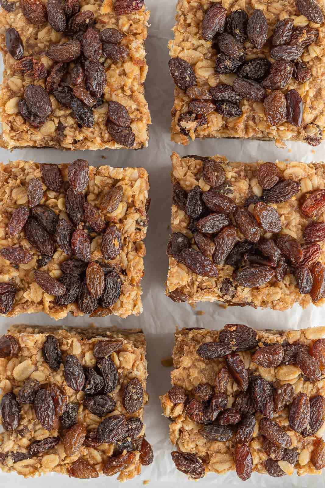 Cinnamon raisin oatmeal squares arranged on parchment paper.
