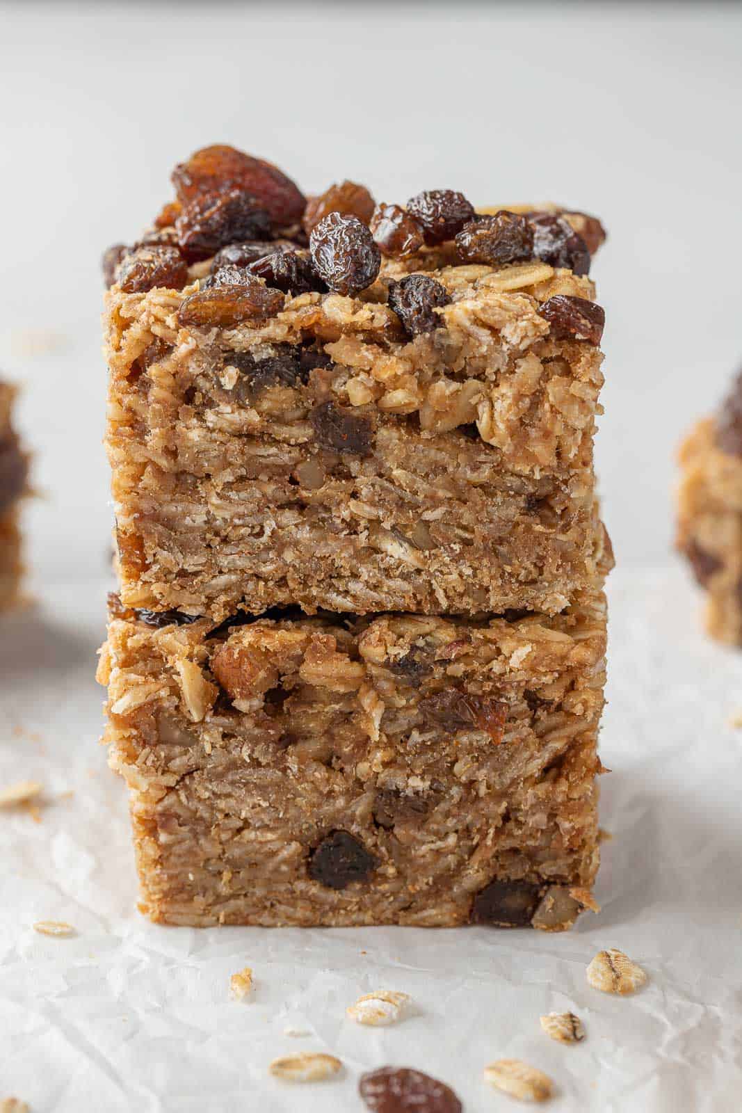 Two cinnamon raisin oatmeal bars in a stack.