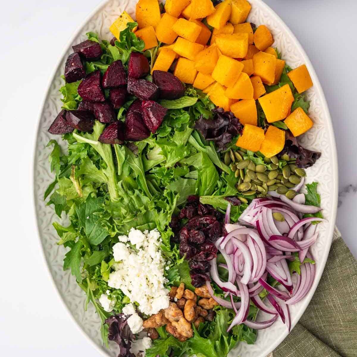 Ingredients for Butternut Squash Salad with feta are arranged on a platter.