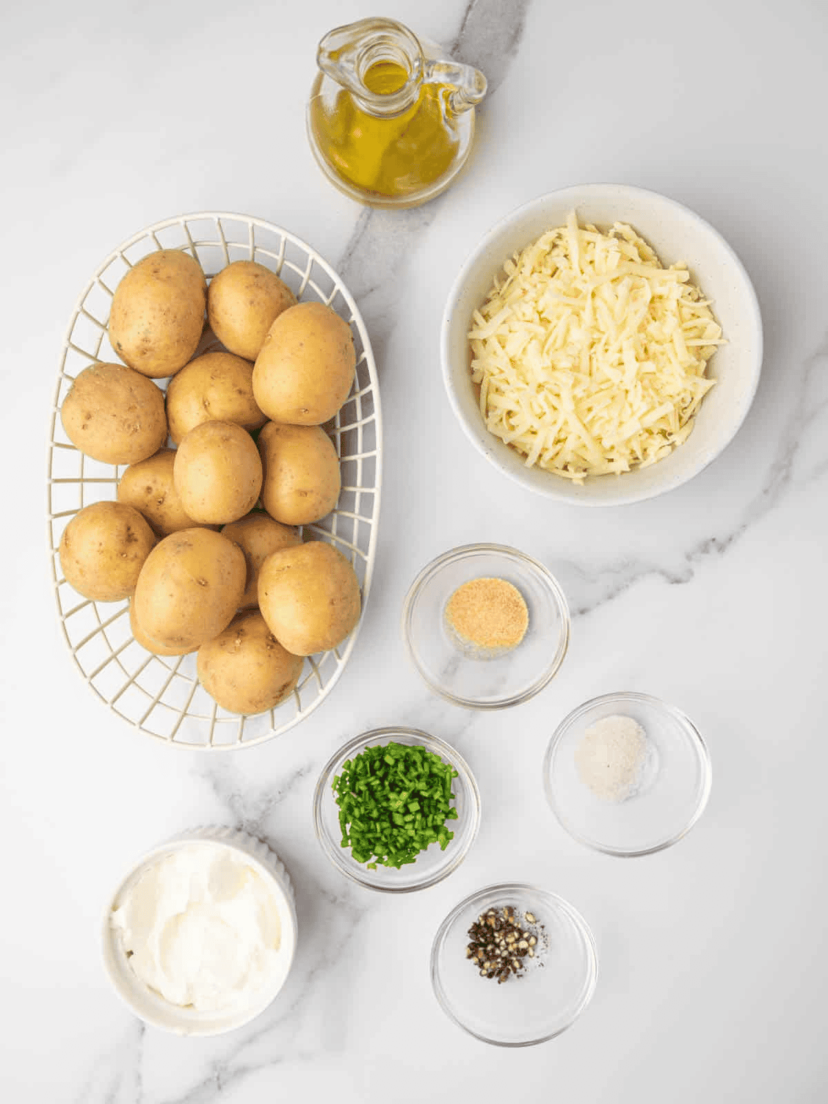 Yukon gold potatoes arranged with mozzarella, olive oil, sour cream, chives, and seasonings.