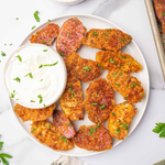 Parmesan-crusted fingerling potatoes served with sour cream.
