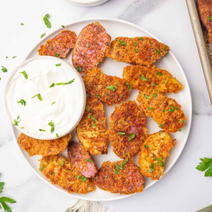 Parmesan-crusted fingerling potatoes served with sour cream.