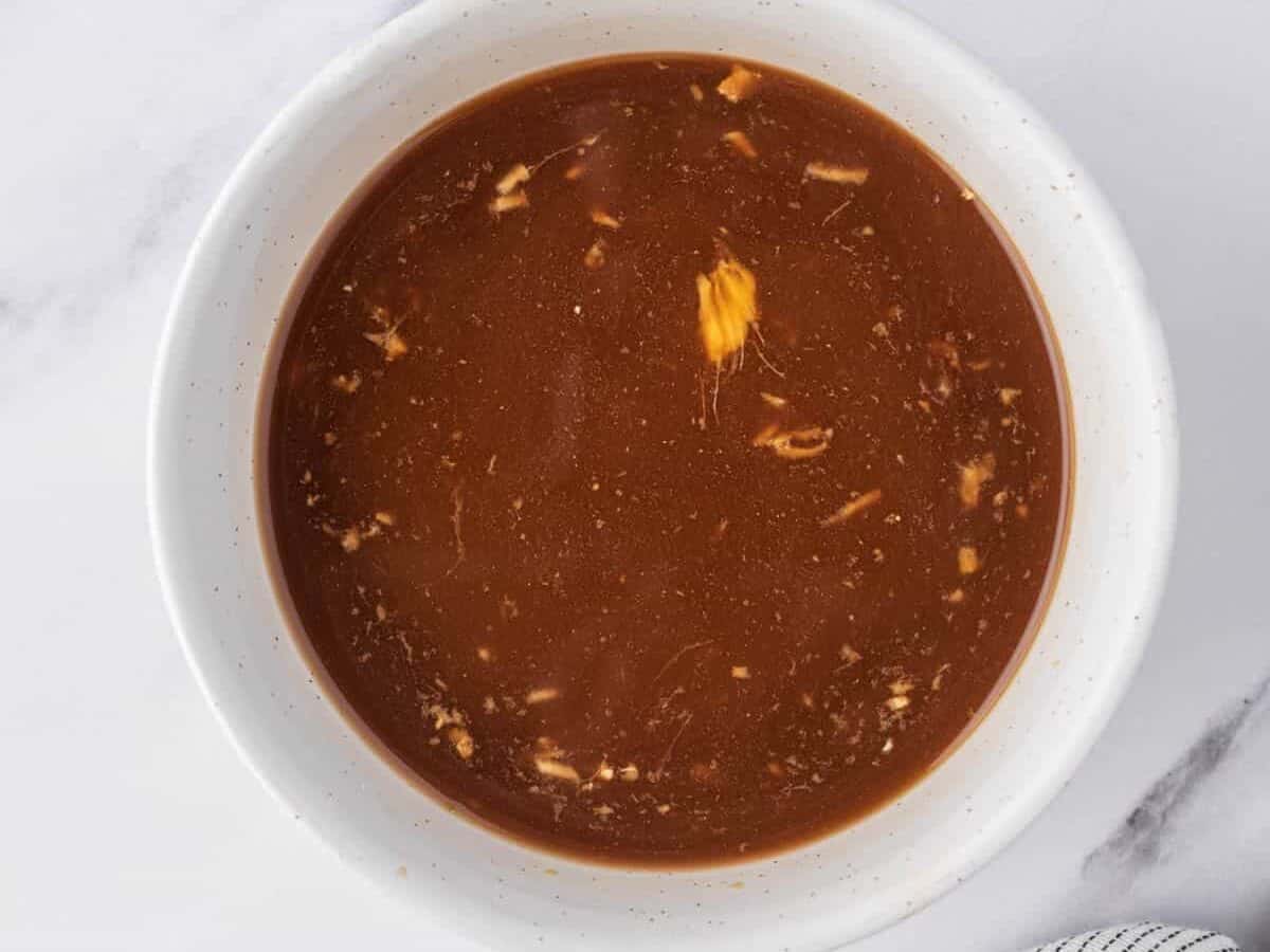 Chicken stir fry sauce is a small white dish.