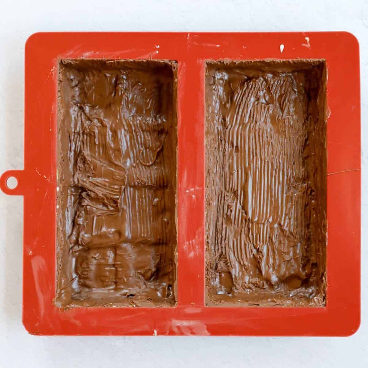 Process of coating the chocolate mold with chocolate to make the outer shell.