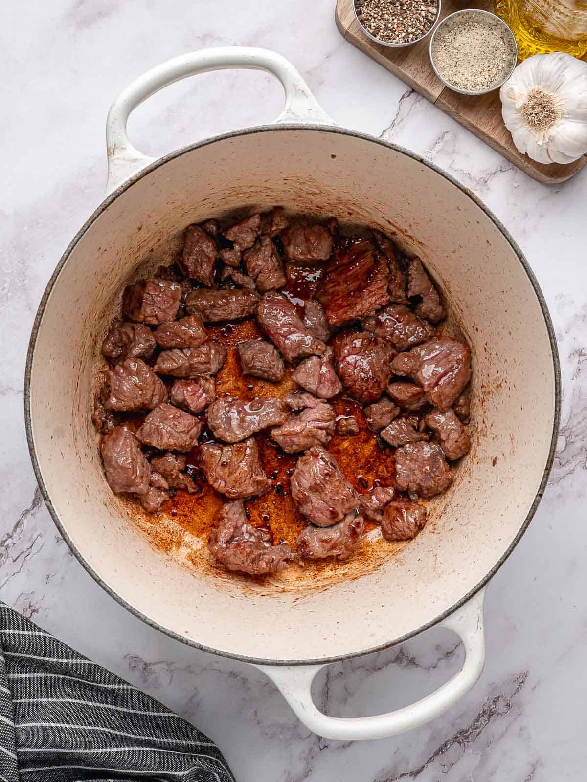 Beef browned in a large pot.