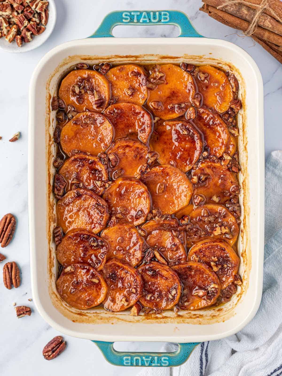 Candied Sweet Potato Casserole with tender slices, pecans and a glossy brown sugar topping.
