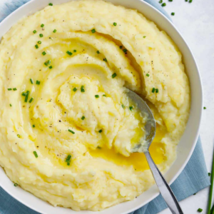 Easy mashed potatoes topped with melted butter, chopped chives, and black pepper.