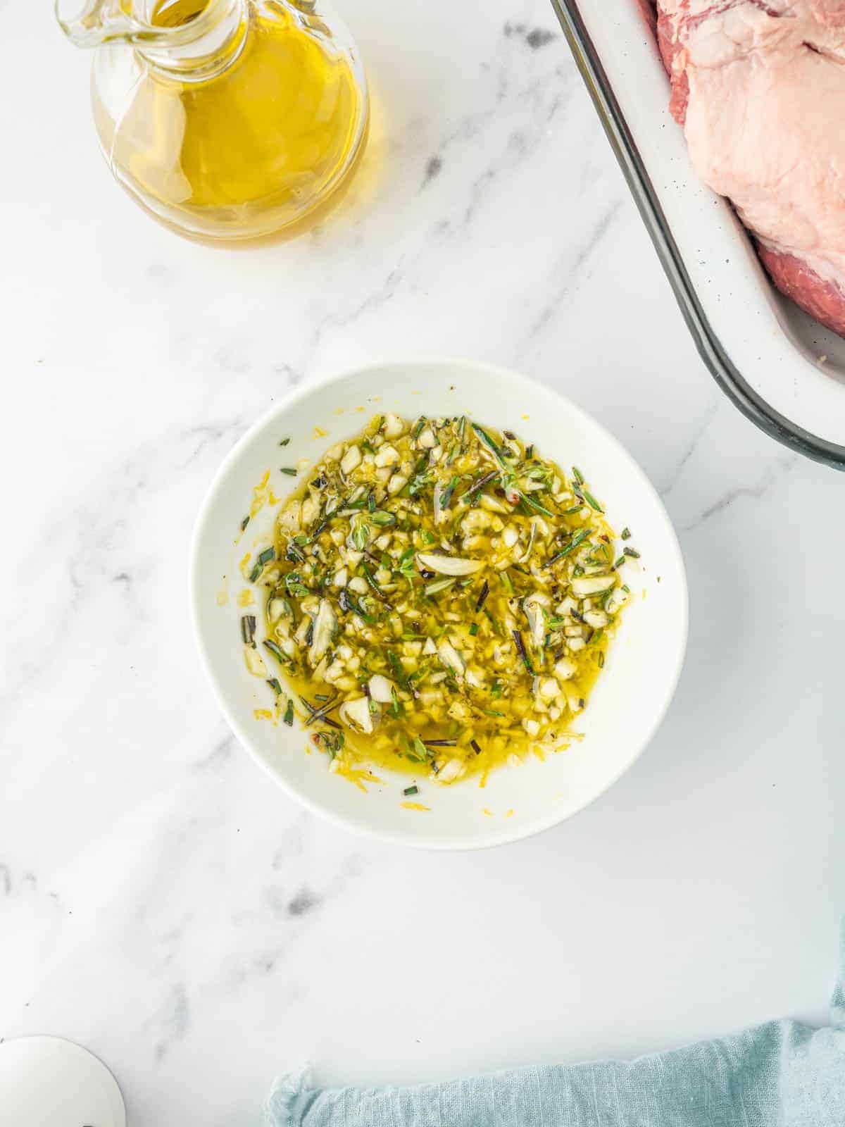 Garlic, rosemary, thyme, lemon zest, and olive oil combined for the lamb marinade.