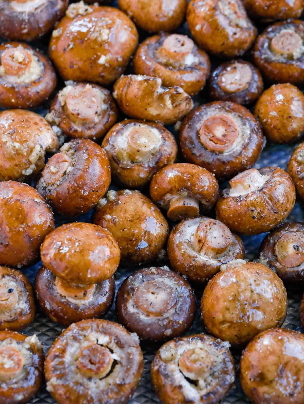 Garlic butter mushrooms coated with minced garlic and black pepper before roasting.
