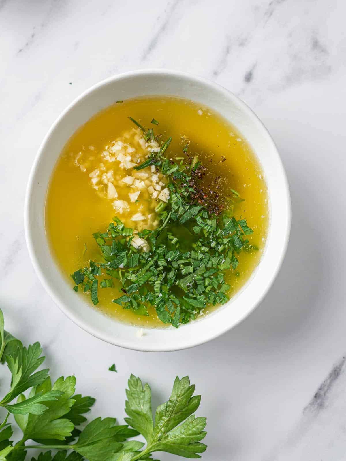 Melted butter mixed with garlic, parsley, rosemary, and seasonings.