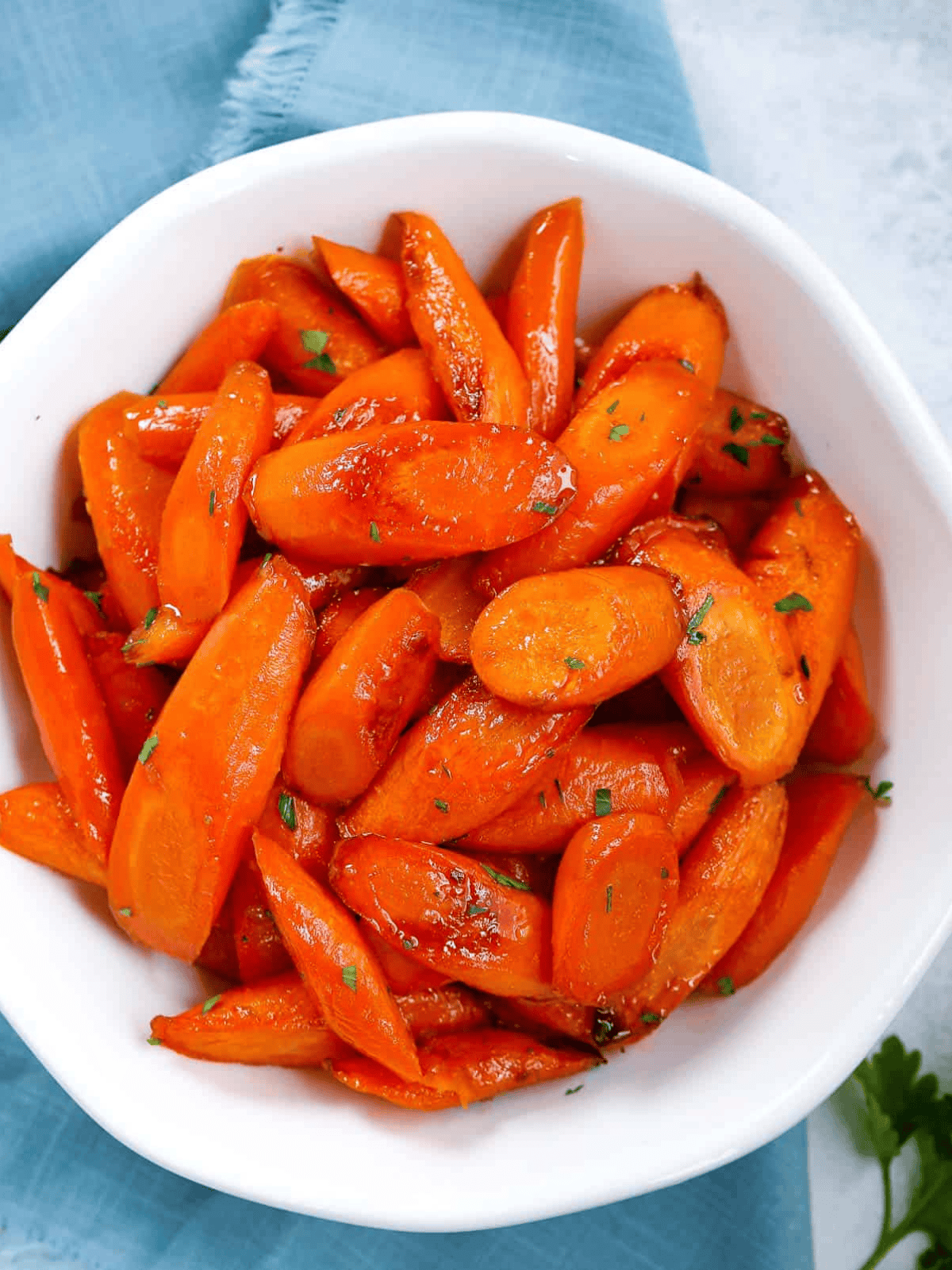 Brown sugar glazed carrots served in a white plate.
