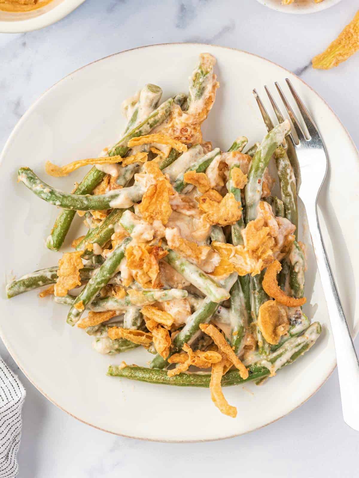 Cheesy green bean casserole served on a plate.