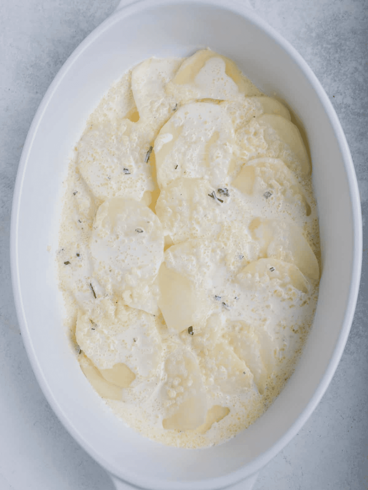 Potato slices covered with garlic and herb cream.