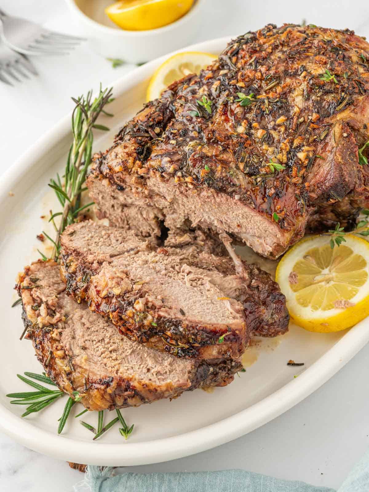 Sliced Roasted Leg of Lamb with garlic, rosemary, thyme, and lemon.