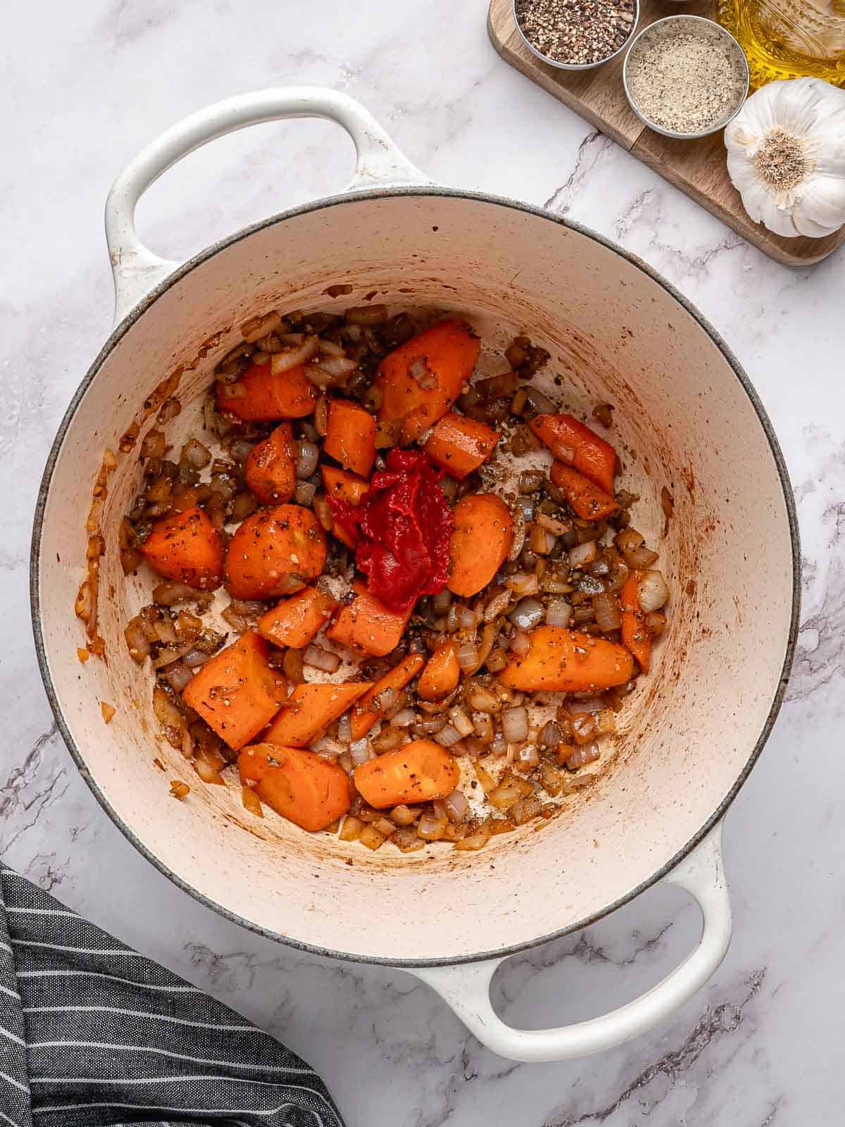 Tomato paste mixed with the seasoned carrots and onions.
