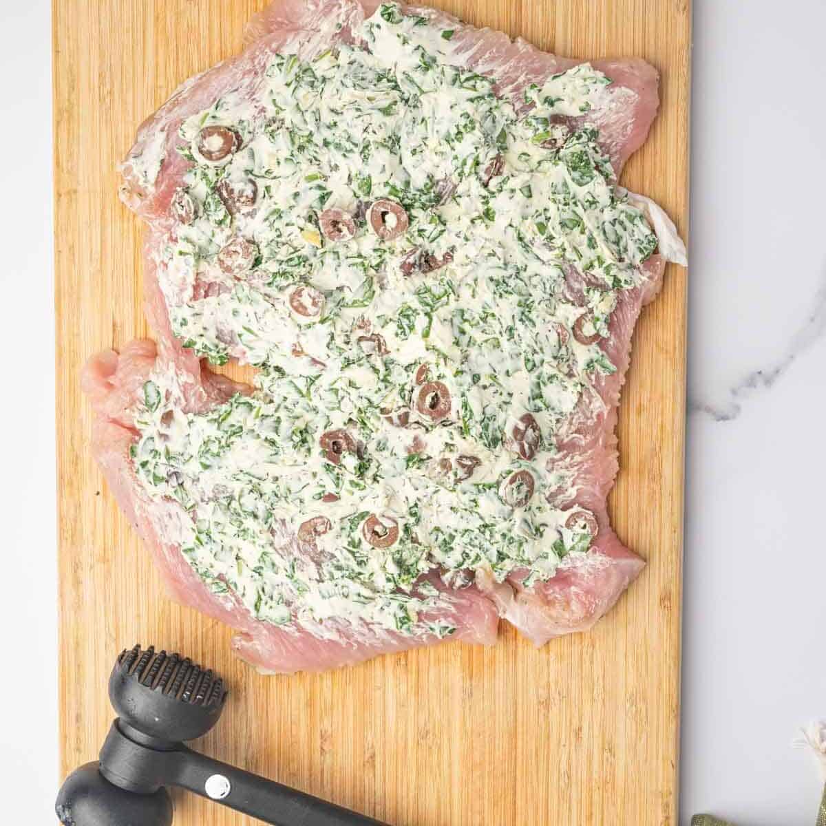 Turkey breast spread with cream cheese, spinach, and olive filling.