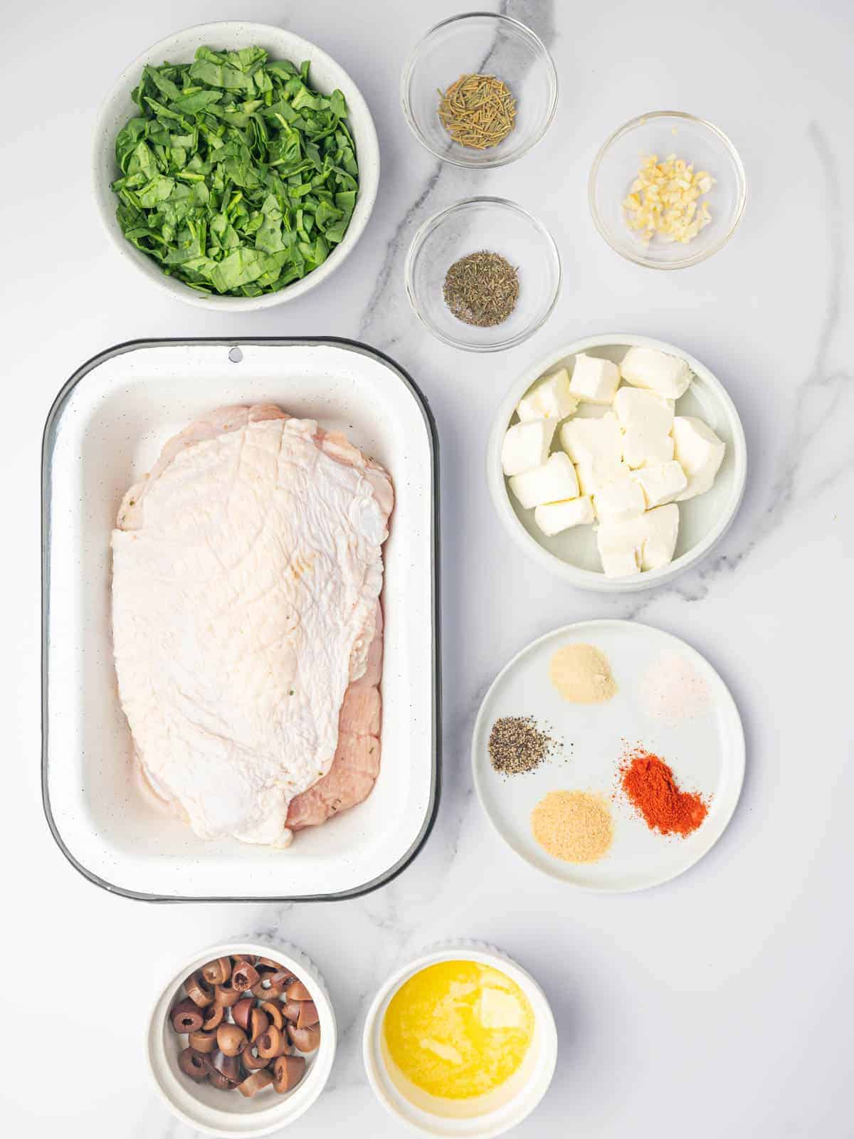 Turkey breast with cream cheese, spinach, olives, herbs, butter, and seasonings.