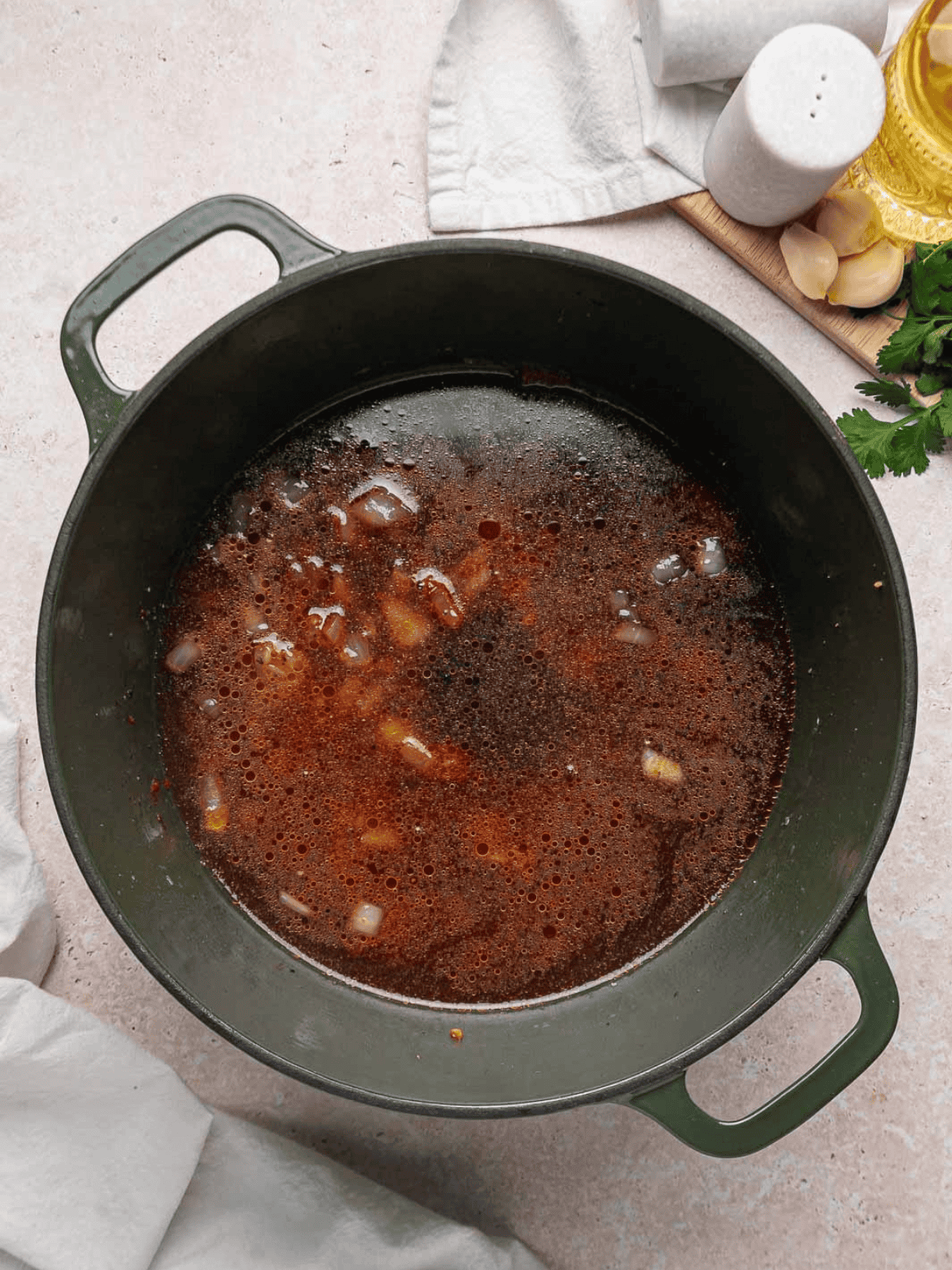Beef broth, beef base, and Worcestershire sauce simmering in the Dutch oven.