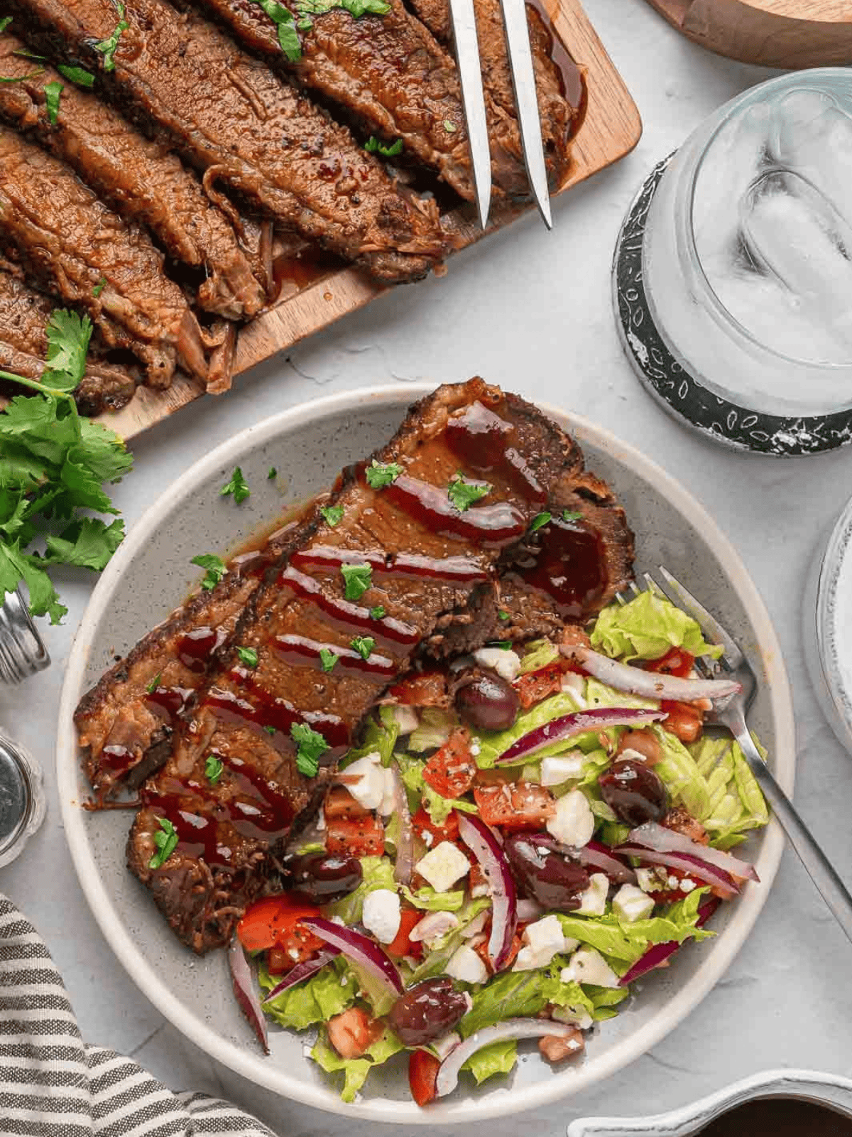 Sliced brisket served with a fresh salad on the side.