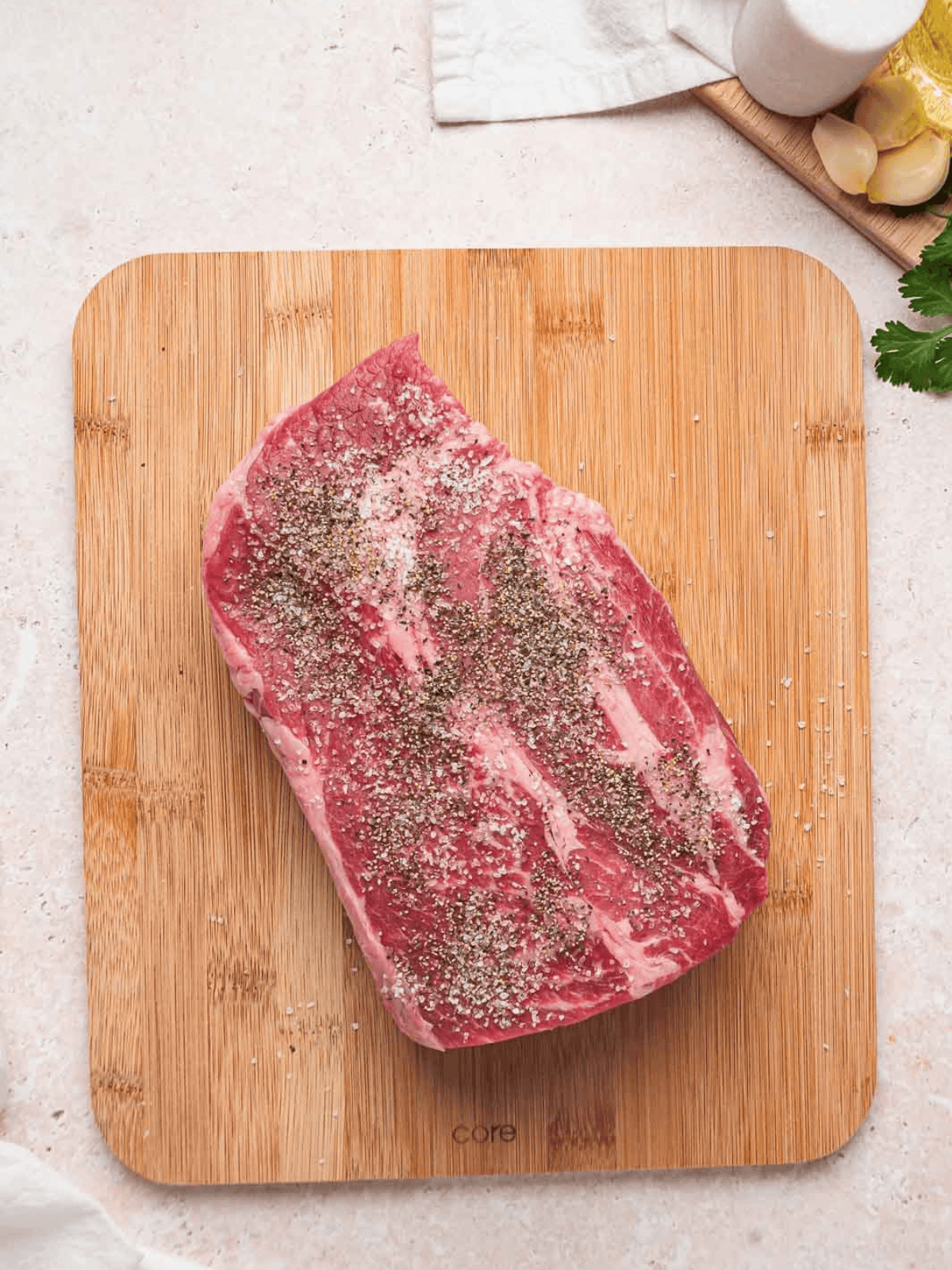 Boneless chuck roast seasoned with kosher salt and black pepper.