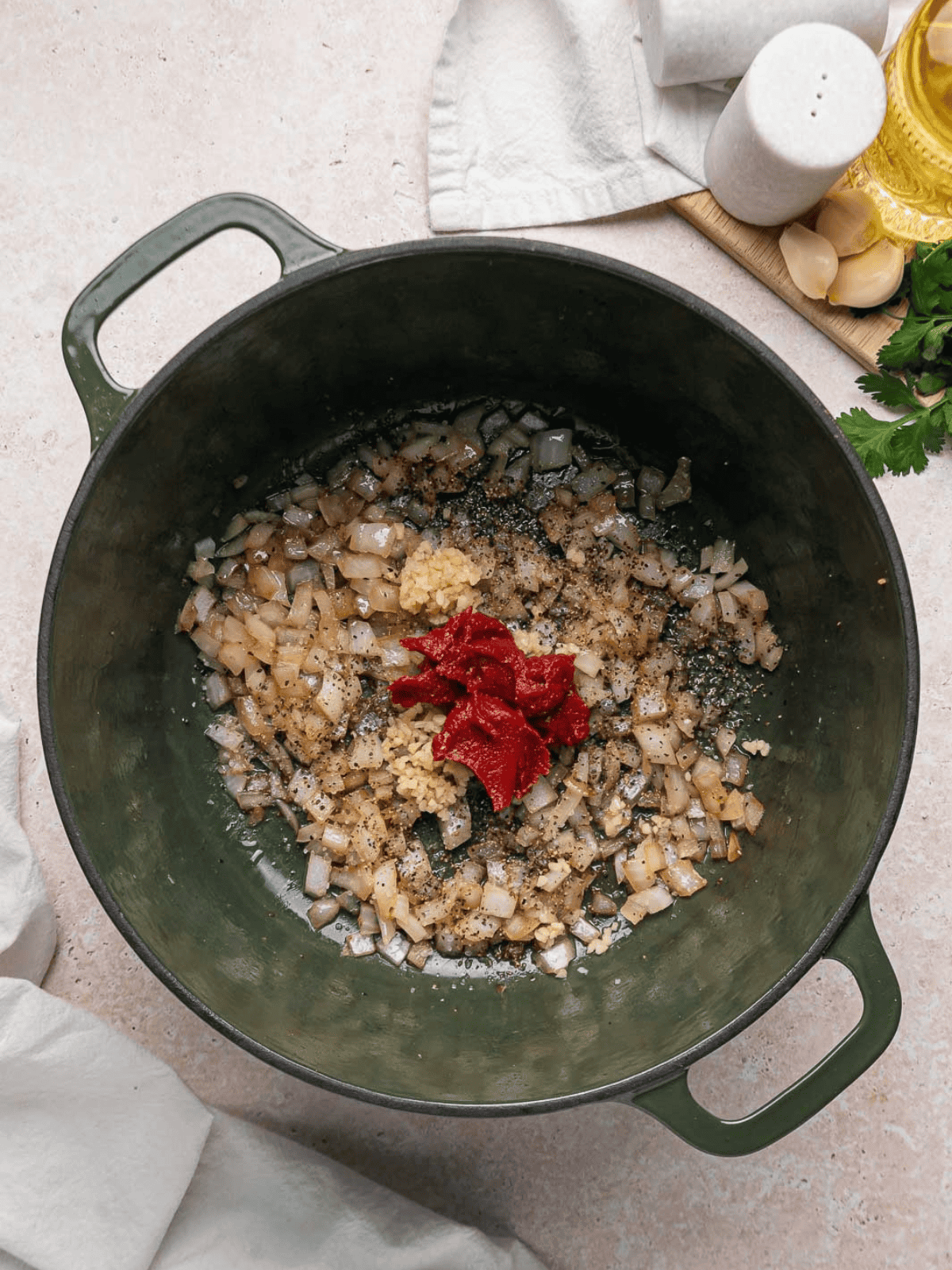 Cooked onions with minced garlic and tomato paste in the Dutch oven.