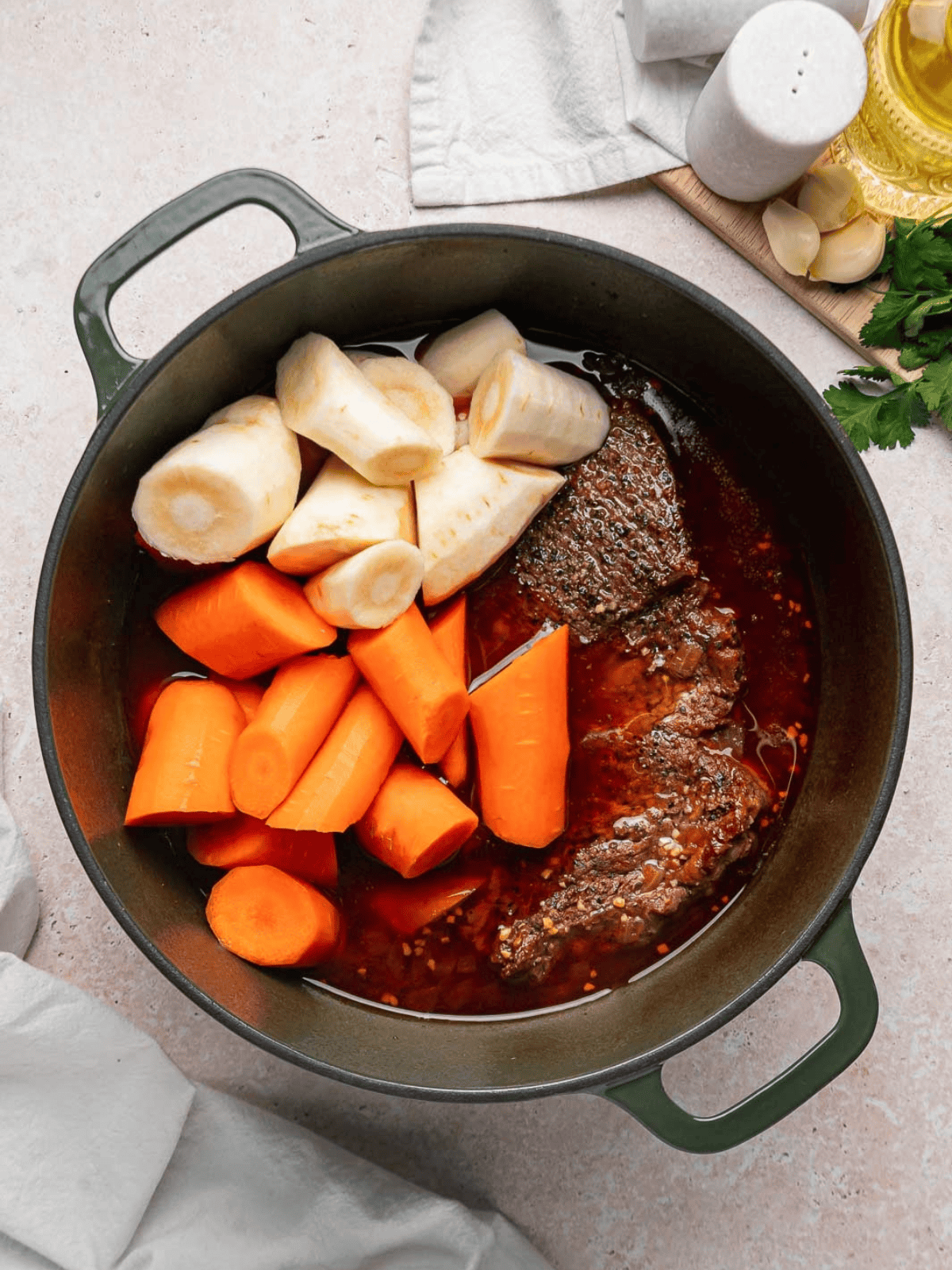 Carrots and parsnips arranged around the braised chuck roast.